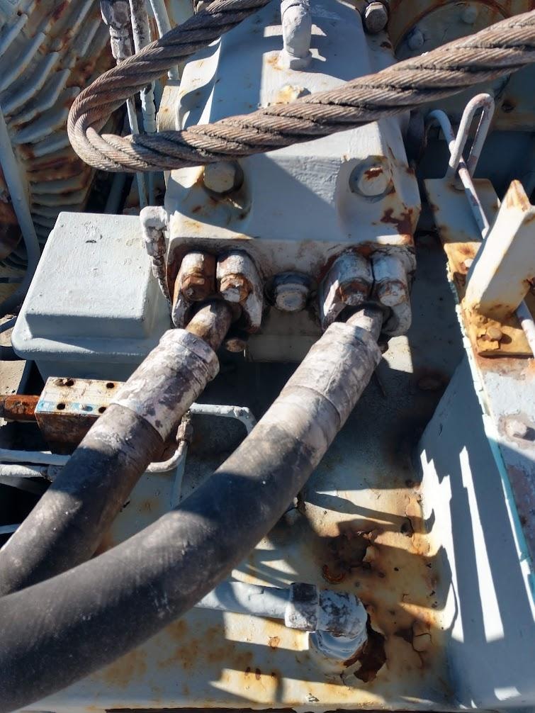 Heavy-duty hydraulic hose fittings on a naval vessel deck winch system