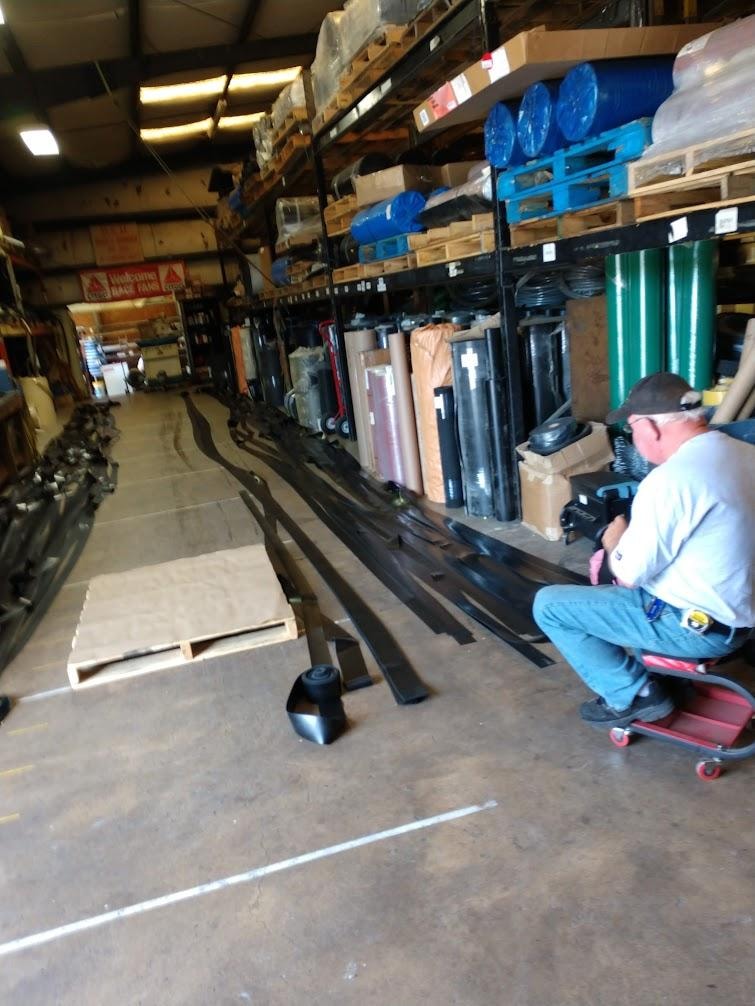 B&B Hose technician rolling and cutting rubber strip for shipboard applications