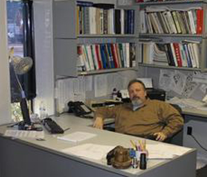 a man sitting on a chair in the office cabin