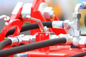 A red machine with many different types of hoses.