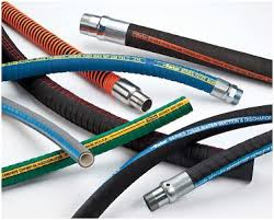 A bunch of different types of hoses are laying on the ground